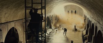 Movie still from “Skyfall” (2012), directed by Sam Mendes – A group of people standing around in a tunnel; Extreme Wide shot, Low angle