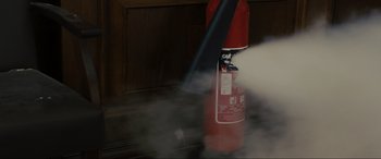 Movie still from “Skyfall” (2012), directed by Sam Mendes – A fire extinguisher with smoke coming out of it; Extreme Close Up shot, High angle