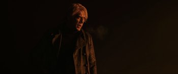Movie still from “Skyfall” (2012), directed by Sam Mendes – A man with blonde hair wearing a black jacket; Medium shot, Low angle