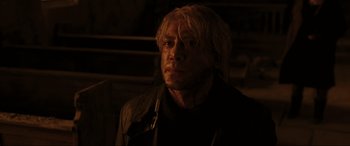 Movie still from “Skyfall” (2012), directed by Sam Mendes – A person with long blonde hair; Close Up shot, Over the shoulder angle