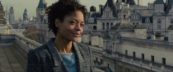 Movie still from “Skyfall” (2012), directed by Sam Mendes – A woman standing in front of an old building; Close Up shot, Low angle