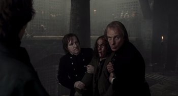 Movie still from “Sleepy Hollow” (1999), directed by Tim Burton – A group of men standing next to each other; Medium shot, Over the shoulder angle