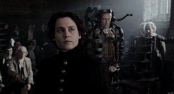 Movie still from “Sleepy Hollow” (1999), directed by Tim Burton – A woman standing next to a man in a room; Medium shot, Low angle
