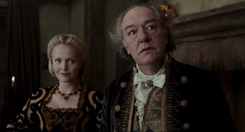 Movie still from “Sleepy Hollow” (1999), directed by Tim Burton – A man and a woman standing next to each other; Medium shot, Low angle