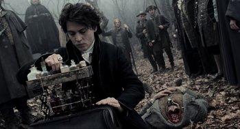 Movie still from “Sleepy Hollow” (1999), directed by Tim Burton – A group of people in the woods looking at something; Medium shot, High angle