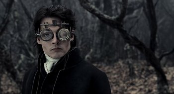 Movie still from “Sleepy Hollow” (1999), directed by Tim Burton – A man wearing a pair of glasses and a black coat; Close Up shot, Over the shoulder angle