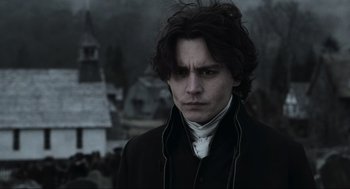 Movie still from “Sleepy Hollow” (1999), directed by Tim Burton – A man with long dark hair wearing a black jacket; Close Up shot, Low angle