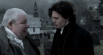 Movie still from “Sleepy Hollow” (1999), directed by Tim Burton – Two men standing next to each other in a graveyard; Close Up shot, Over the shoulder angle