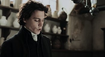 Movie still from “Sleepy Hollow” (1999), directed by Tim Burton – A man in a black jacket is standing in a room; Close Up shot, Low angle