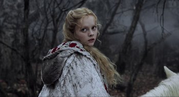 Movie still from “Sleepy Hollow” (1999), directed by Tim Burton – A young girl in a fur coat standing in the woods; Close Up shot, Low angle