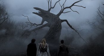 Movie still from “Sleepy Hollow” (1999), directed by Tim Burton – A group of people standing in front of a large tree; Wide shot, Low angle