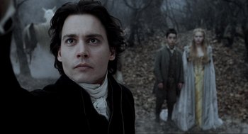 Movie still from “Sleepy Hollow” (1999), directed by Tim Burton – A man and a young woman in a forest; Close Up shot, Over the shoulder angle