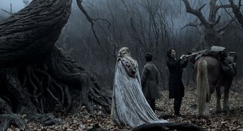 Movie still from “Sleepy Hollow” (1999), directed by Tim Burton – A group of people standing in the woods near a tree; Wide shot, Over the shoulder angle