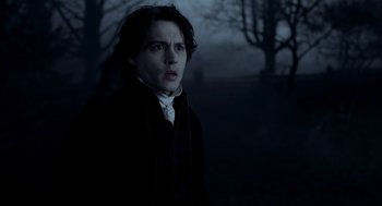 Movie still from “Sleepy Hollow” (1999), directed by Tim Burton – A man in a black jacket standing in the dark; Close Up shot, Over the shoulder angle