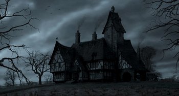 Movie still from “Sleepy Hollow” (1999), directed by Tim Burton – An image of an old house in the middle of the night; Extreme Wide shot, Low angle
