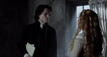 Movie still from “Sleepy Hollow” (1999), directed by Tim Burton – A man and a woman standing next to each other in front of a window; Medium shot, Over the shoulder angle