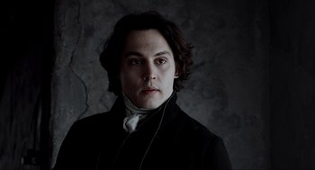 Movie still from “Sleepy Hollow” (1999), directed by Tim Burton – A young man wearing a black jacket and a white shirt; Close Up shot, Low angle