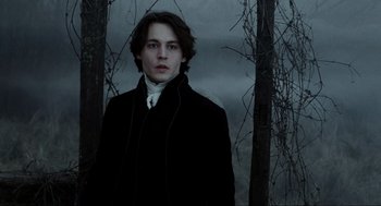 Movie still from “Sleepy Hollow” (1999), directed by Tim Burton – A young man in a black coat and white shirt; Close Up shot, Low angle