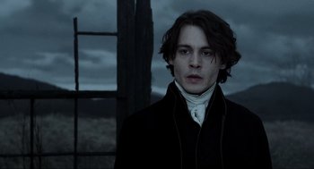 Movie still from “Sleepy Hollow” (1999), directed by Tim Burton – A man in a black jacket standing in front of a window; Close Up shot, Low angle