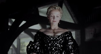 Movie still from “Sleepy Hollow” (1999), directed by Tim Burton – A woman wearing a black dress and a gold necklace; Medium shot, Low angle