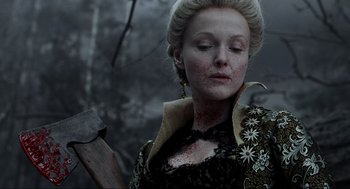 Movie still from “Sleepy Hollow” (1999), directed by Tim Burton – A woman in a black and white dress holding a hammer; Close Up shot, Over the shoulder angle