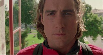 Movie still from “Bottle Rocket” (1996), directed by Wes Anderson – A person with long hair; Close Up shot, Low angle