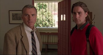 Movie still from “Bottle Rocket” (1996), directed by Wes Anderson – Two men standing next to each other in front of a window; Medium shot, Low angle