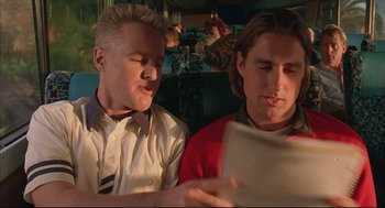 Movie still from “Bottle Rocket” (1996), directed by Wes Anderson – A couple of men sitting next to each other on a train; Close Up shot, Low angle