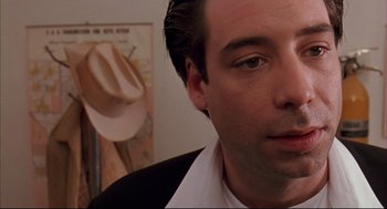 Movie still from “Bottle Rocket” (1996), directed by Wes Anderson – A person wearing a suit and tie; Close Up shot, Low angle