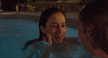 Movie still from “Bottle Rocket” (1996), directed by Wes Anderson – A woman sitting in a swimming pool at night; Close Up shot, Over the shoulder angle