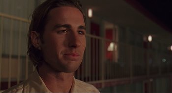 Movie still from “Bottle Rocket” (1996), directed by Wes Anderson – A person wearing a white shirt; Close Up shot, Over the shoulder angle