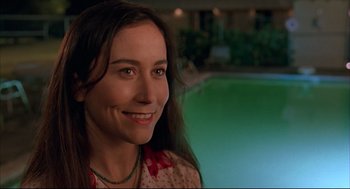 Movie still from “Bottle Rocket” (1996), directed by Wes Anderson – A person near a swimming pool; Close Up shot, High angle