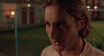 Movie still from “Bottle Rocket” (1996), directed by Wes Anderson – A person with long hair; Close Up shot, Low angle