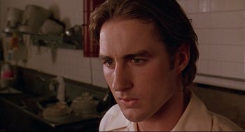 Movie still from “Bottle Rocket” (1996), directed by Wes Anderson – A person with long hair; Close Up shot, Low angle