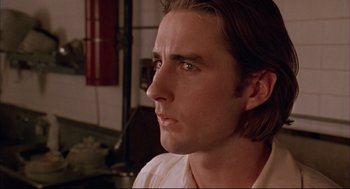 Movie still from “Bottle Rocket” (1996), directed by Wes Anderson – A person with long brown hair; Close Up shot, Low angle