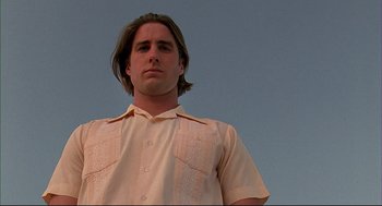 Movie still from “Bottle Rocket” (1996), directed by Wes Anderson – A person wearing a button up shirt; Close Up shot, Low angle