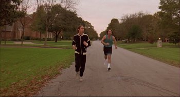 Movie still from “Bottle Rocket” (1996), directed by Wes Anderson – Two men running down the middle of the street; Wide shot, High angle