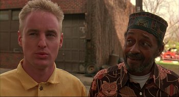 Movie still from “Bottle Rocket” (1996), directed by Wes Anderson – Two men standing next to each other on the street; Close Up shot, Low angle