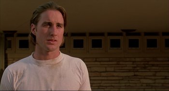 Movie still from “Bottle Rocket” (1996), directed by Wes Anderson – A person wearing a white shirt; Close Up shot, Low angle
