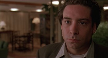 Movie still from “Bottle Rocket” (1996), directed by Wes Anderson – A person wearing a suit and tie; Close Up shot, Low angle