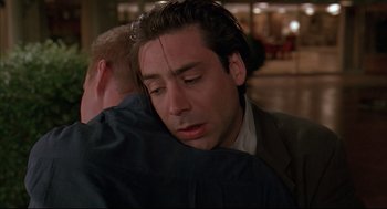 Movie still from “Bottle Rocket” (1996), directed by Wes Anderson – A man hugging another man with his eyes closed; Close Up shot, Over the shoulder angle
