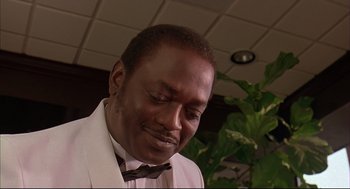 Movie still from “Bottle Rocket” (1996), directed by Wes Anderson – A person wearing a suit and bow tie; Close Up shot, Low angle