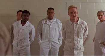 Movie still from “Bottle Rocket” (1996), directed by Wes Anderson – A group of men standing next to each other in white overalls; Medium shot, Low angle