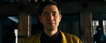 Movie still from “Snake Eyes” (2021), directed by Robert Schwentke – A person wearing a yellow jacket; Close Up shot, Low angle