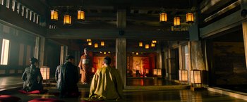 Movie still from “Snake Eyes” (2021), directed by Robert Schwentke – Two men in traditional garb in an asian temple; Wide shot, Low angle