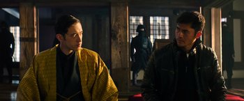 Movie still from “Snake Eyes” (2021), directed by Robert Schwentke – A man and a woman in front of a door; Medium shot, Over the shoulder angle