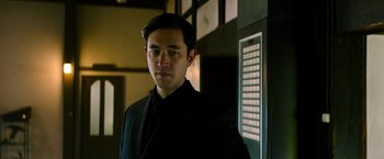 Movie still from “Snake Eyes” (2021), directed by Robert Schwentke – A man in a suit standing in front of an elevator; Close Up shot, Low angle