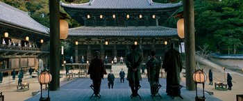 Movie still from “Snake Eyes” (2021), directed by Robert Schwentke – A group of people standing in front of a building; Extreme Wide shot, High angle