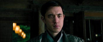 Movie still from “Snake Eyes” (2021), directed by Robert Schwentke – A person wearing a robe; Close Up shot, Low angle