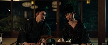 Movie still from “Snake Eyes” (2021), directed by Robert Schwentke – A man and a woman sitting at a dinner table; Close Up shot, Over the shoulder angle